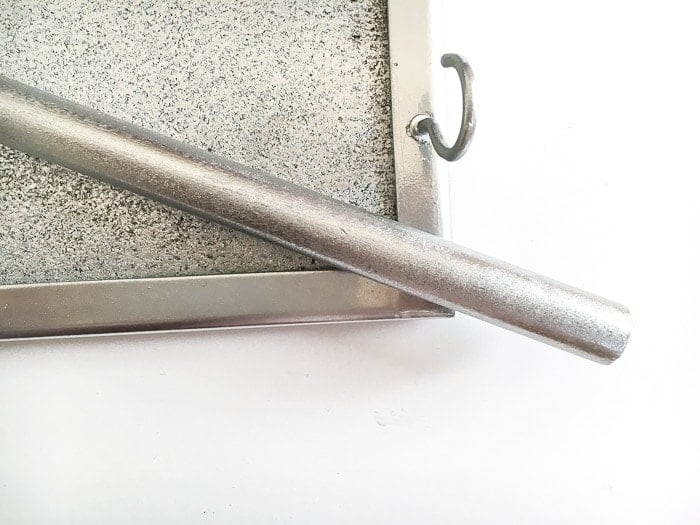 Silver painted dowel hook and cork board to make a DIY jewelry organizer