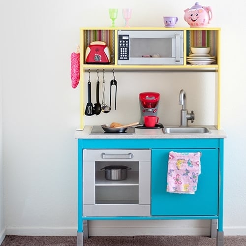 This Ikea Duktig Kitchen hack takes the plain Ikea kitchen and transforms it into a fun and colorful kids play kitchen with just a bit of paint and paper!