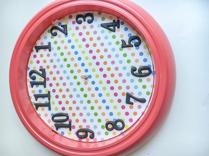 Ikea Rusch wall clock assembled with scrap book paper and numbers