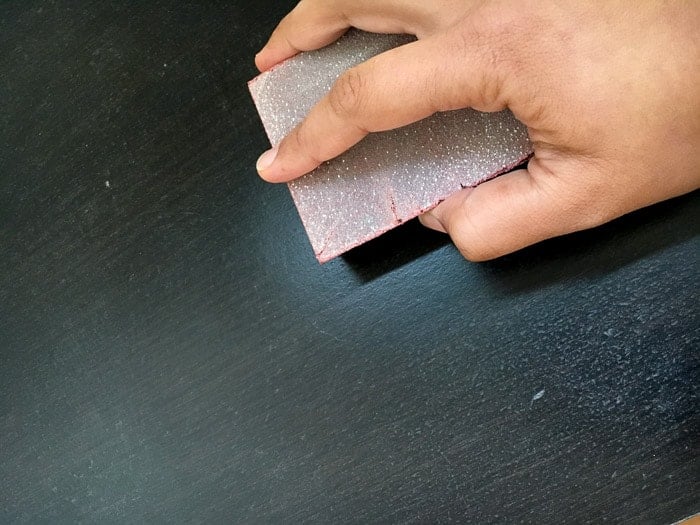 Sanding the surface of Ikea malm to prepare for DIY crackle paint