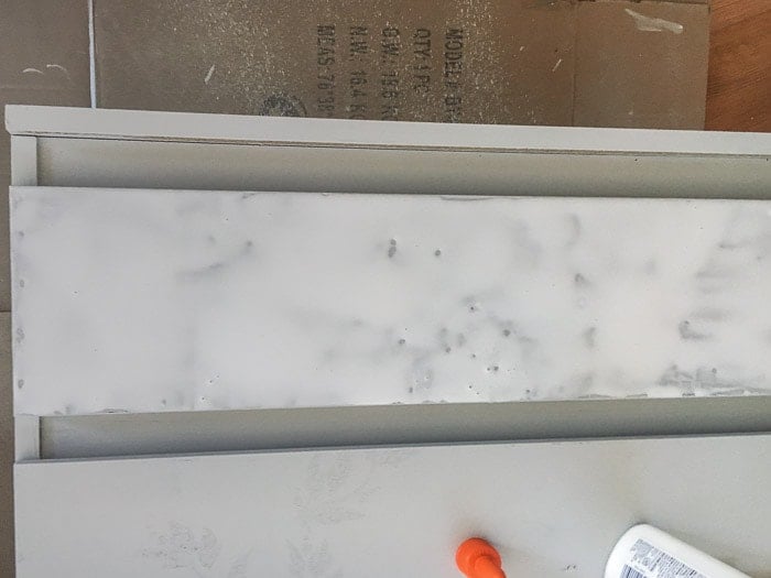 adding a layer of glue on furniture to make crackle paint