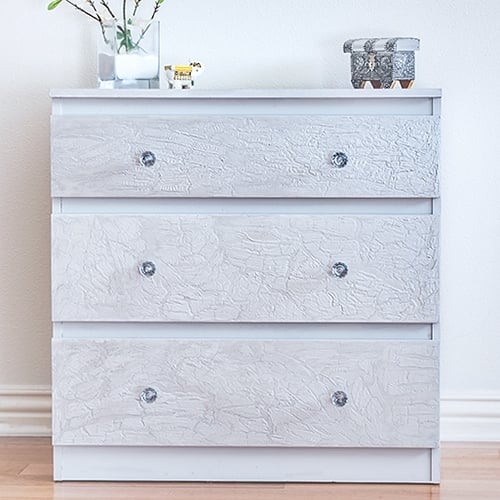 Ikea Malm dresser hack with a unique cracked paint effect. This easy technique transforms a drab Ikea Malm dresser into super glam and chic!