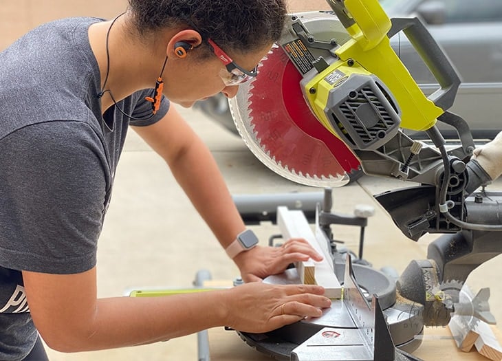 woman working on a miter saw