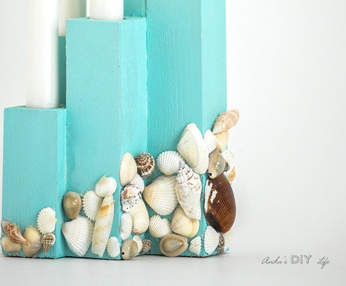 close up of DIY scrap wood candle holder with shells