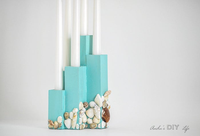DIY scrap wood candle holder with candles.