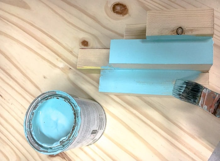Painting the aqua coastal DIY scrap wood candle holder