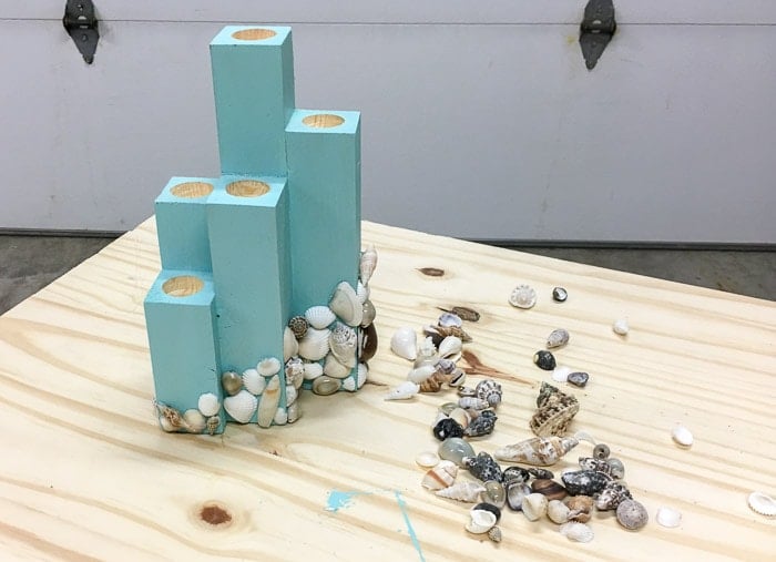 glueing shells to the DIY coastal candle holder