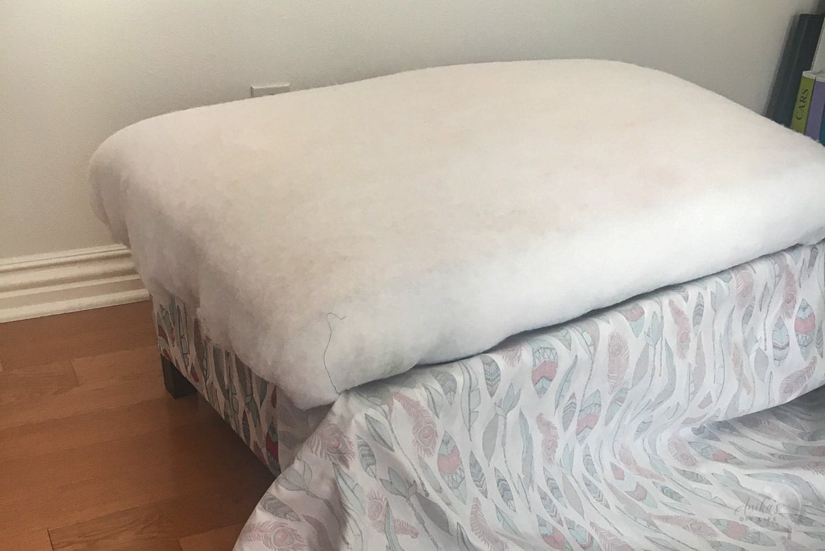 Upholstering the top with batting and fabric