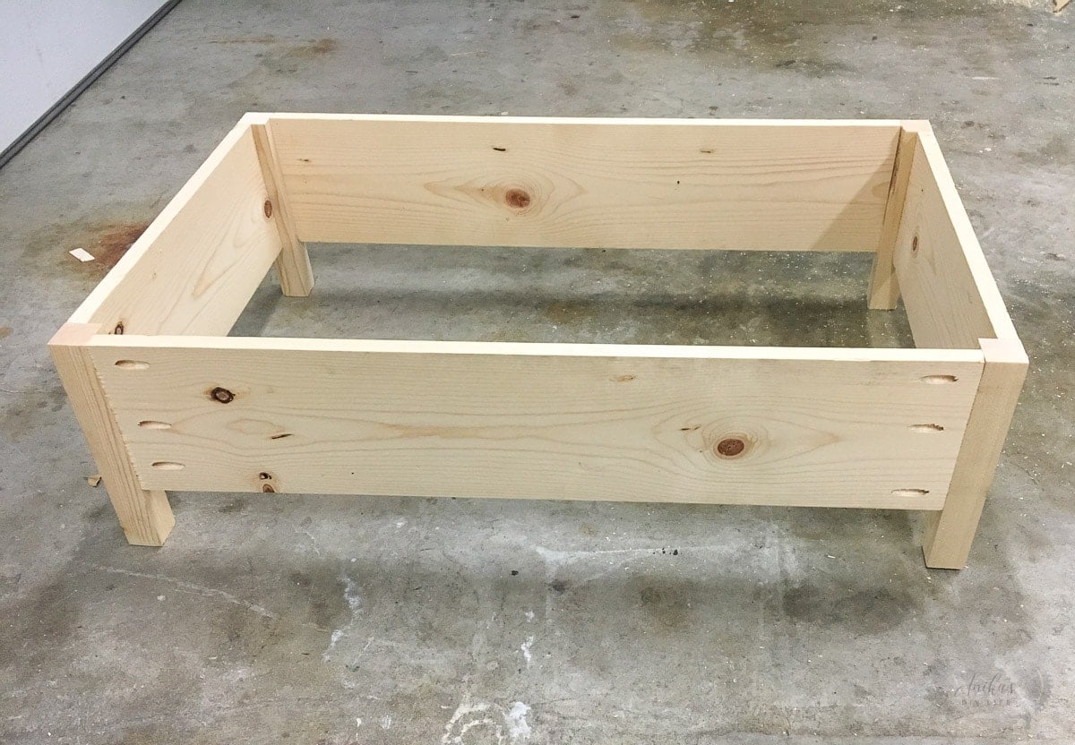 frame of diy upholstered ottoman on garage floor
