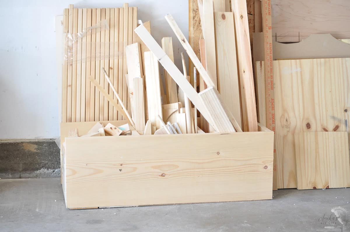wood bin with a pile of wood boards in a workshop