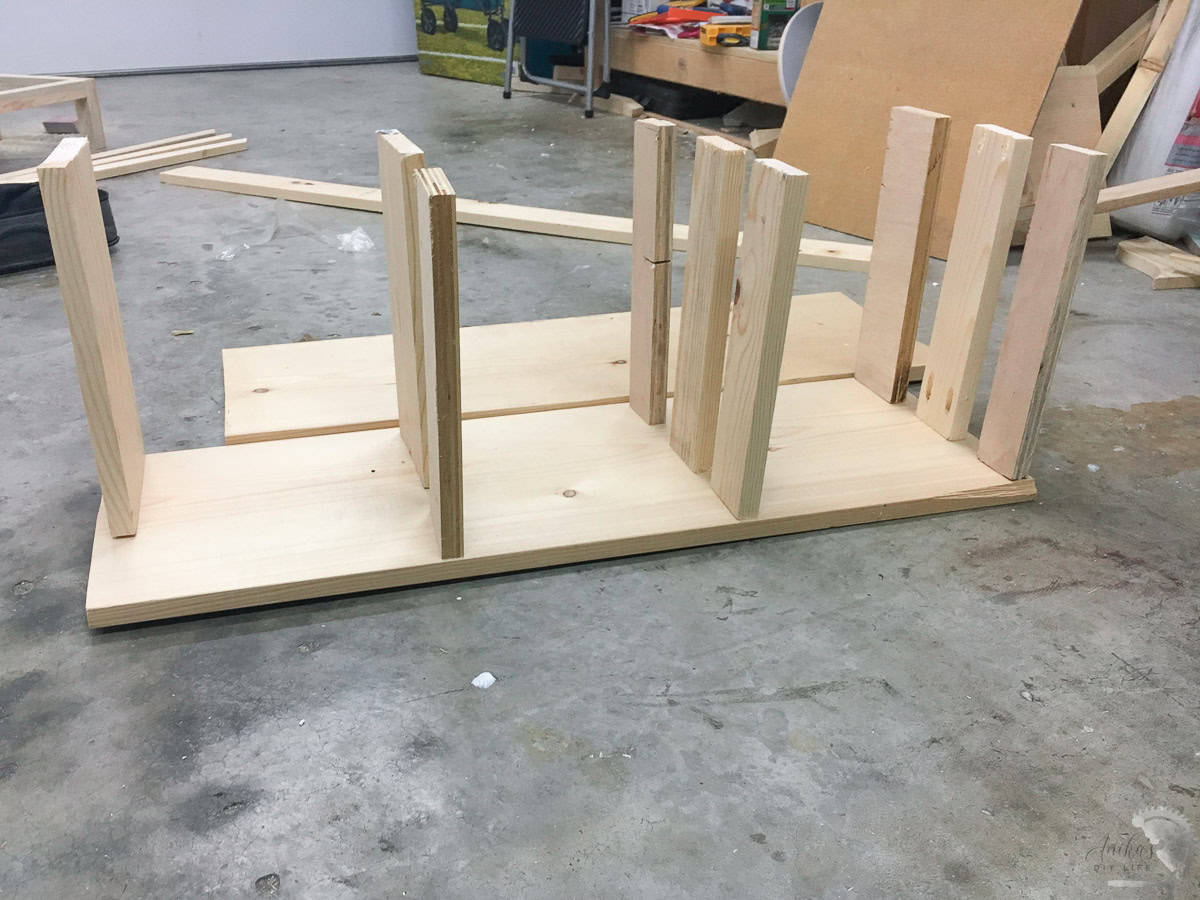 1x3 boards attached to the 1x10 board using pocket hole screws on a garage floor