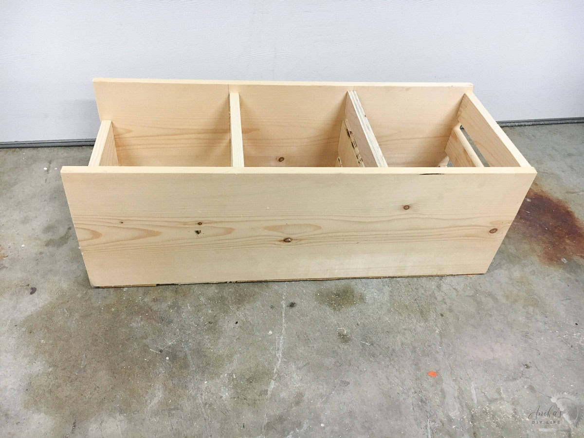 completed scrap wood bin on a garage floor