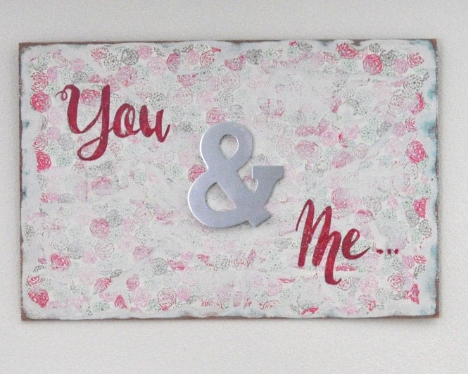 An easy DIY Wall art perfect for the bedroom! Layers of paint and pretty wrapping paper distressed for the most amazing effect.