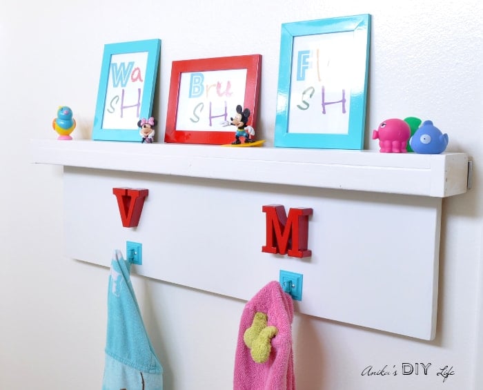 DIY Towel hooks and floating shelf for kids rental bathroom makeover.