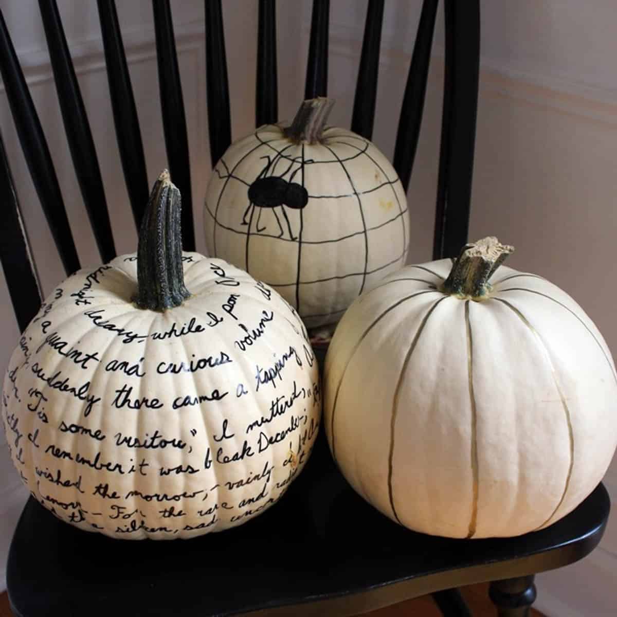 White pumpkins decorated with sharpie marker
