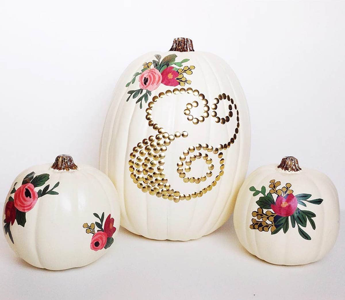 3 white pumpkins with flowers decoupaged on them