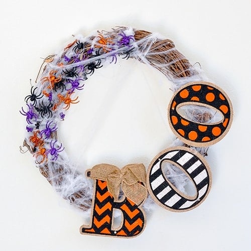 A DIY Halloween wreath that is super easy to make and looks great on the front door too! See how to make it for under $10 and 10 minutes!