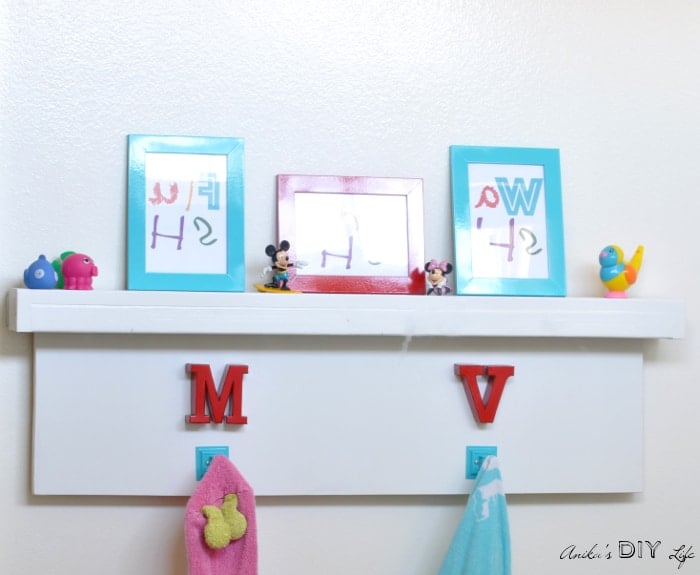 Easy to make DIY towel hooks and floating shelf that goes over the towel bar.