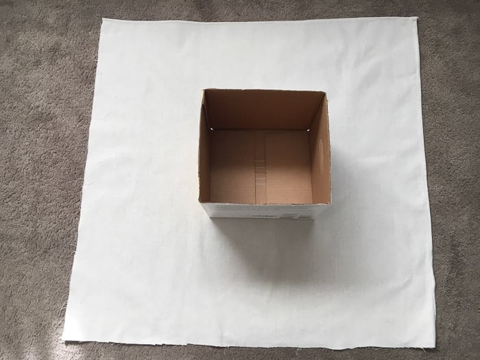 How to make perfect no-sew canvas storage bins by wrapping cardboard boxes in drop cloth. This is a fun easy drop cloth organization project