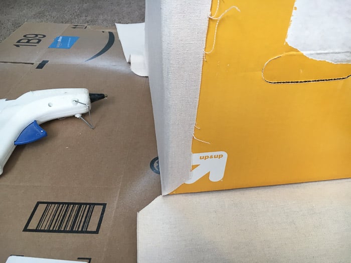 How to make perfect no-sew canvas storage bins by wrapping cardboard boxes in drop cloth. This is a fun easy drop cloth organization project