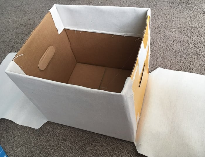 How to make perfect no-sew canvas storage bins by wrapping cardboard boxes in drop cloth. This is a fun easy drop cloth organization project
