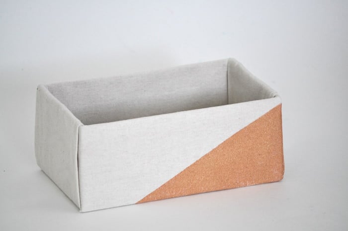 How to make perfect no-sew canvas storage bins by wrapping cardboard boxes in drop cloth. This is a fun easy drop cloth organization project