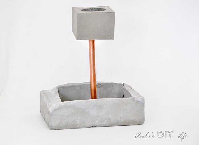 An easy to make tiered concrete planter with copper pipe and accent