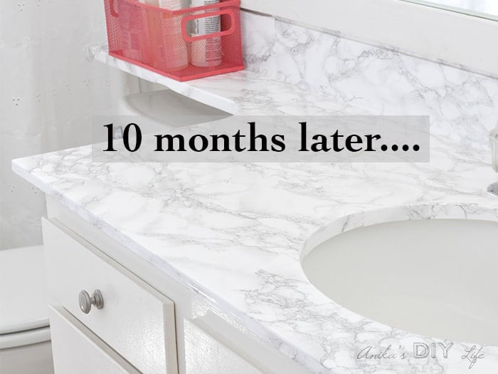 Contact paper countertops in bathroom with text overlay - 10 months later