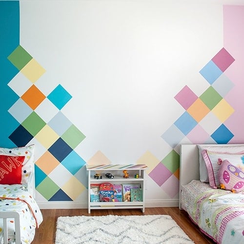 This colorful accent wall is perfect for kids room. Learn how to easily paint this DIY geometric accent wall in a couple of days and create the perfect feature wall.