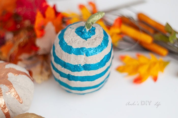 Close up of DIY cement pumpkin wit blue stripes