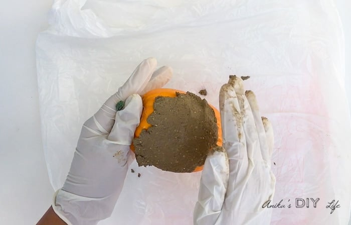 Hand-forming DIY concrete pumpkins using dollar store pumpkins