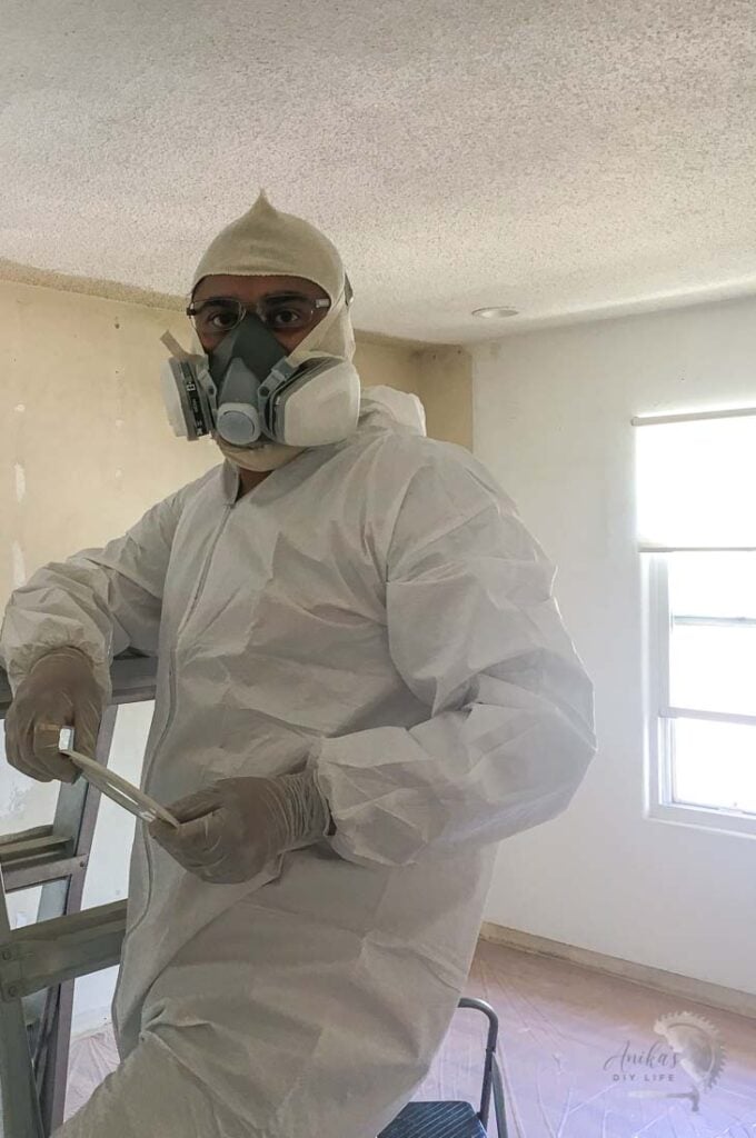 Man dressed for removing popcorn ceiling
