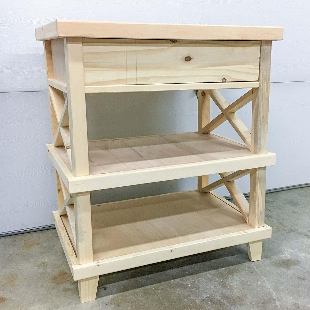unfinished nightstand in garage