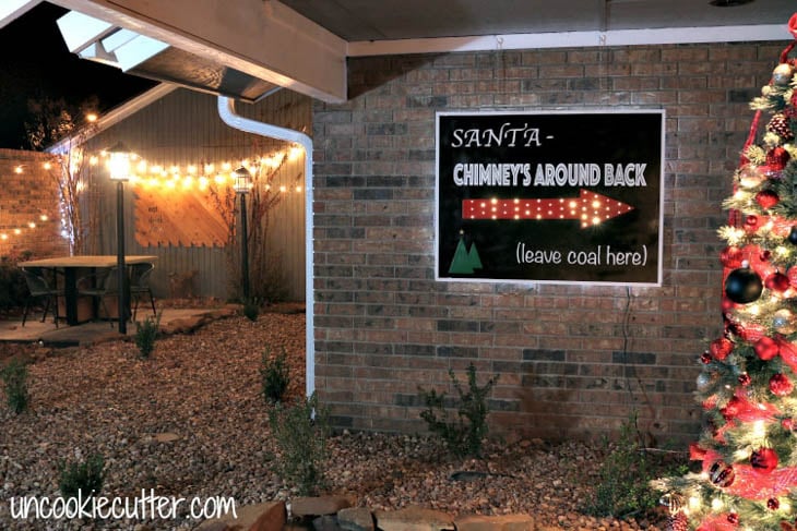 Chimney this way sign hanging on outside house wall