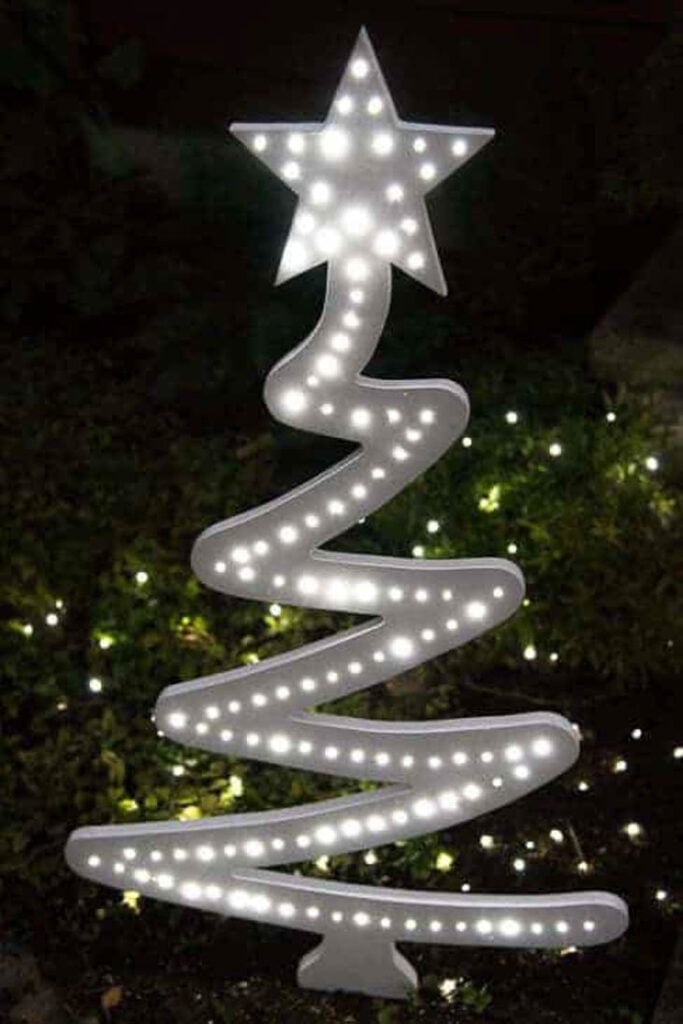 white modern wood Christmas tree lighted at night