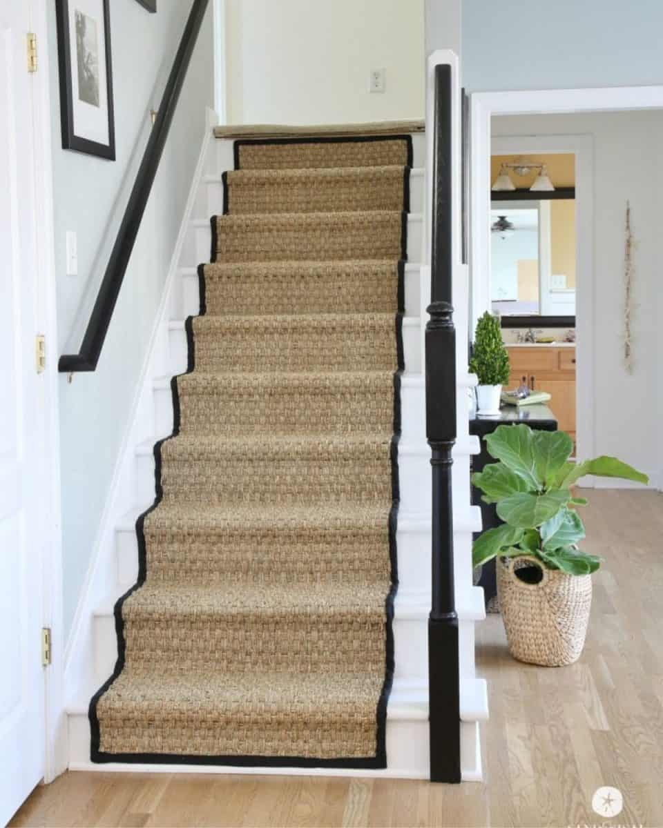 White painted stairs with seagrass runner