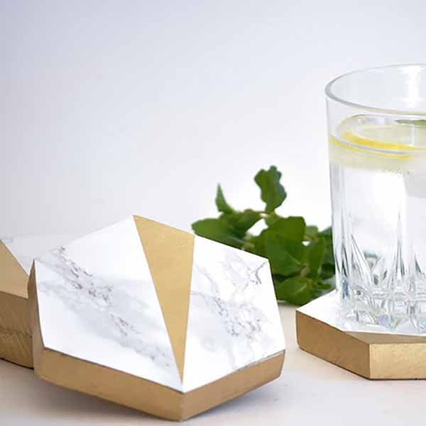 DIY hexagonal marble and gold coasters with glass of water