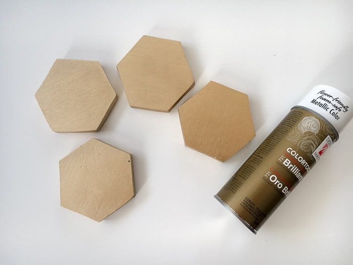 Hexagonal wood shapes spray painted with gold paint