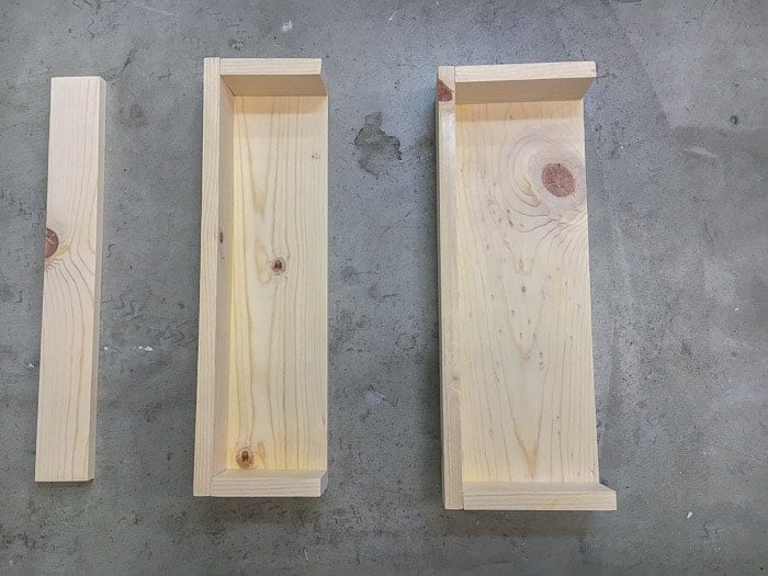 Assembles shelves laid out on floor.