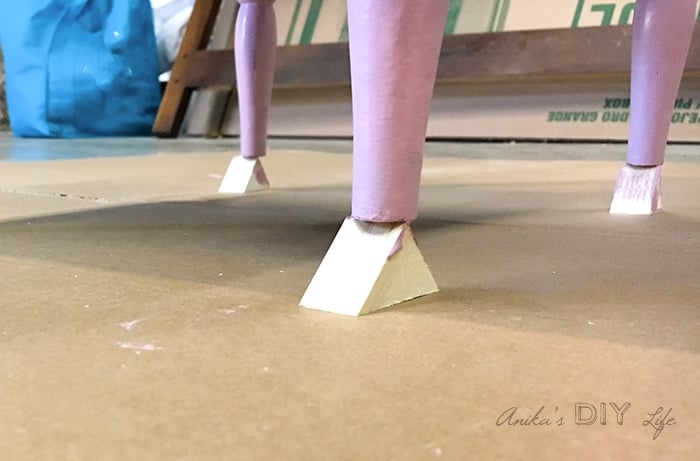 using little wooden blocks to elevate the painting project