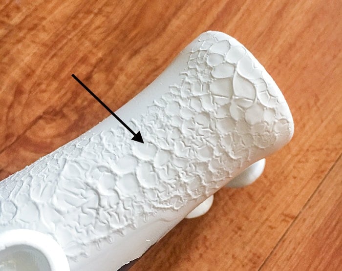Cracked spray paint on flower vase
