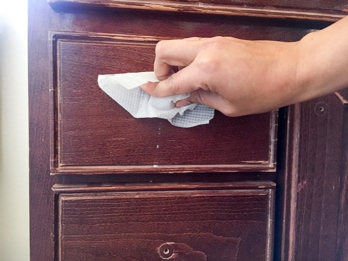 Wiping old vanity down with wet wipes before updating with gel stain