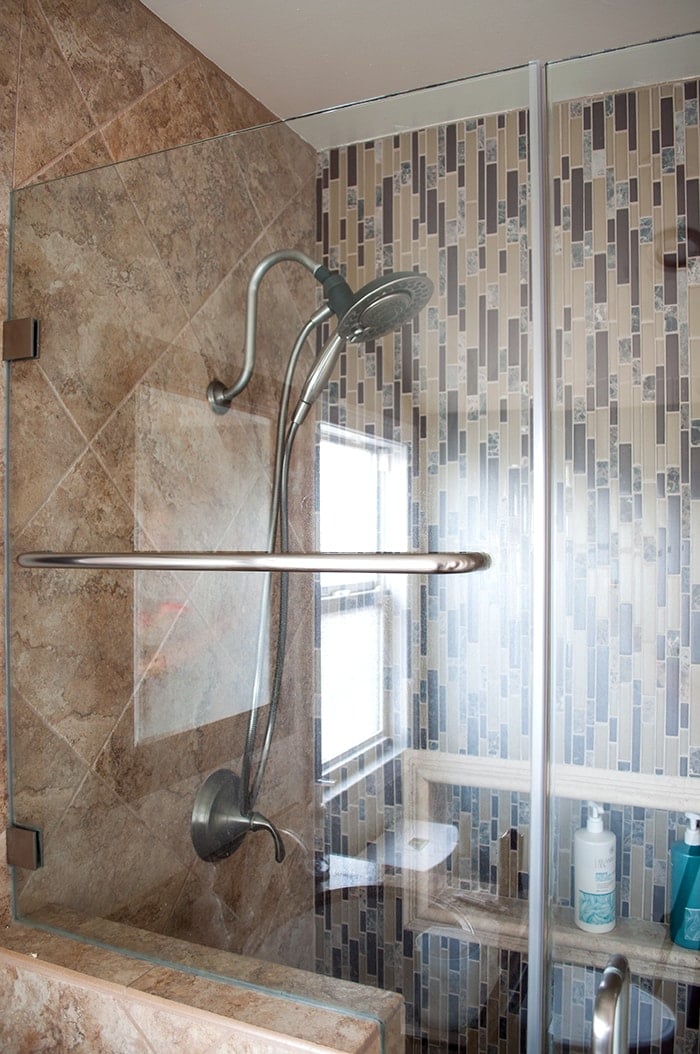 beige and brown shower stall in a small bathroom remodel