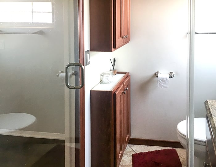 View of two cabinets installed in small bathroom