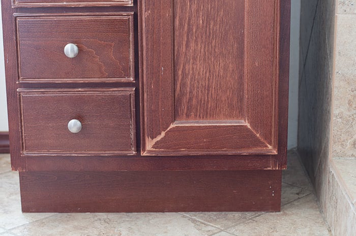 Moisture damage on brown cabinet in small bathroom makeover