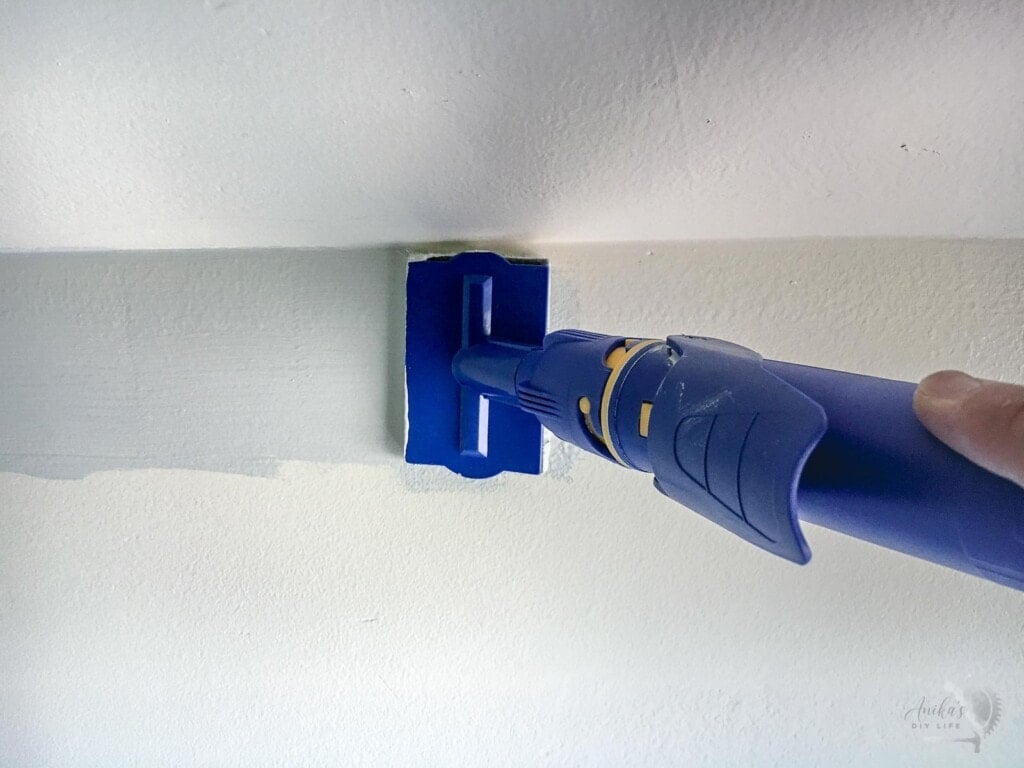 using a quick painter to cut in along the edges of the wall