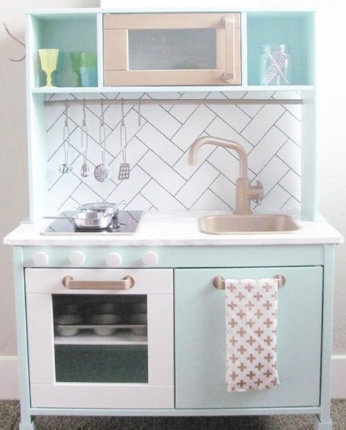 Ikea play kitchen with herringbone tile backsplash