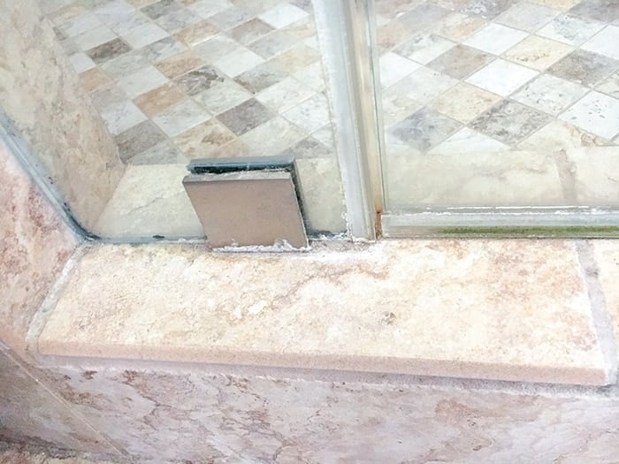 Shower stall corner with hard water build up and mold. Clean it with steam cleaner