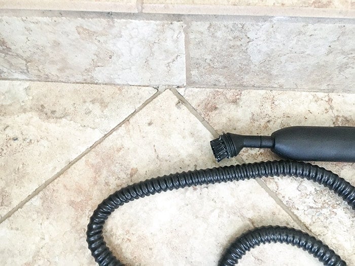Scrubbing grout using a steam cleaner
