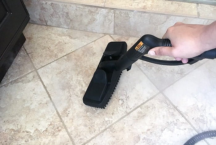 Scrubbing tile with steam cleaner